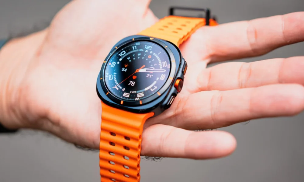 Black and orange smartwatch displaying data on a hand.