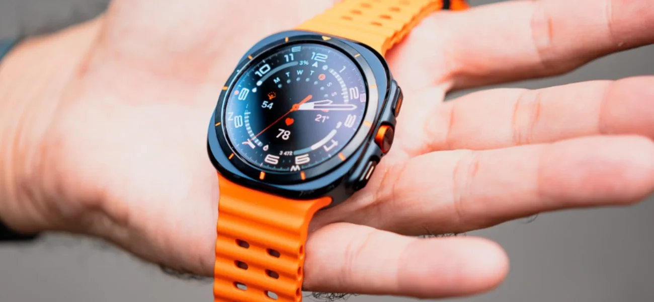 Black and orange smartwatch displaying data on a hand.